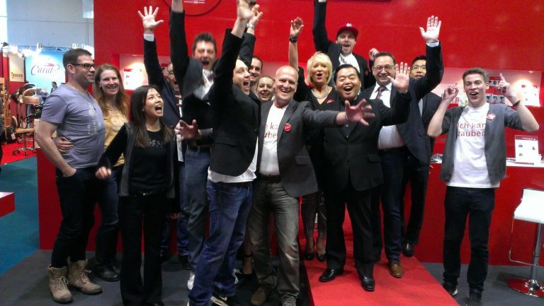 Super Million Hair team celebrating at the Messe Frankfurt hair and beauty exhibition