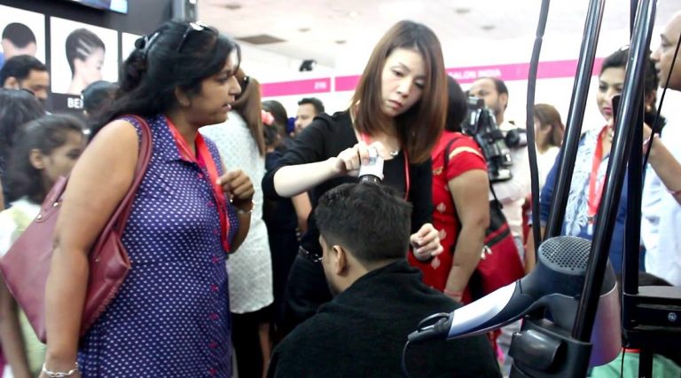 Crowd watching a Super Million Hair demo at a beauty expo