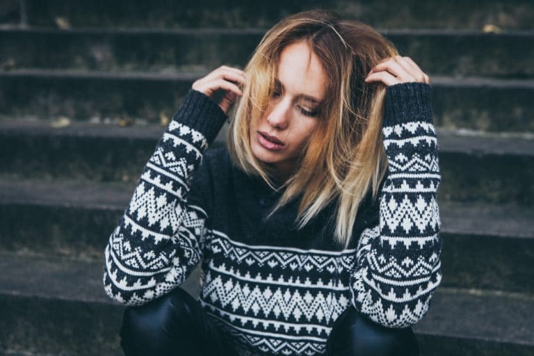 Worried woman holding her hair