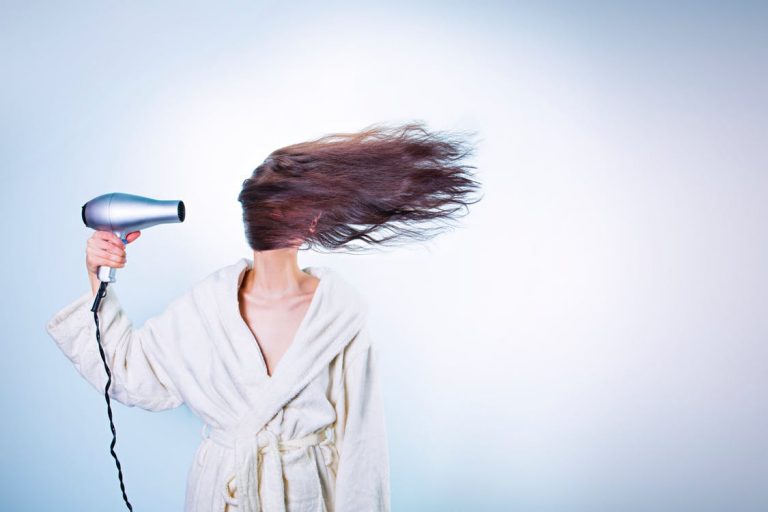 Woman blow-drying her long hair